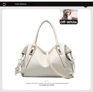 Detail view of large beige leather tote bag with gold zippers and litchi texture