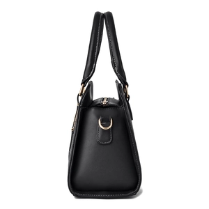 Fashionable black patchwork tote bag with gold zippers and white stitching detail