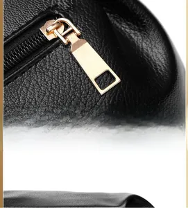 Close-up of elegant golden metal zipper head on black lychee textured leather bag