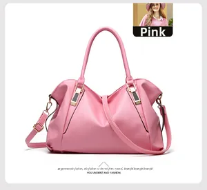Detailed view of pink pebble leather handbag with gold hardware and adjustable strap