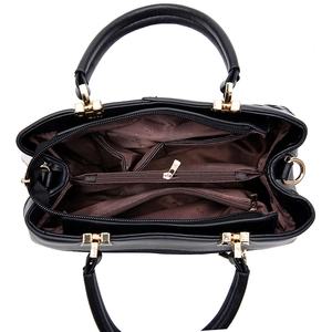 Large black shoulder bag with multiple compartments and spacious brown floral lining