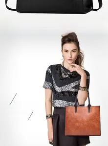 Detail view of brown vintage leather tote bag with litchi texture and sturdy handles