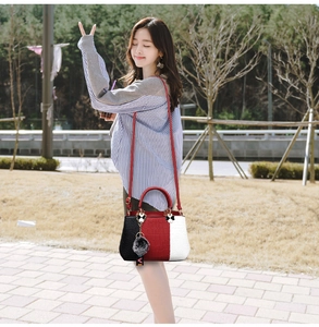 Detail of stone pattern tote bag with plush charm and detachable red shoulder strap