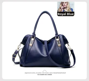 Detail view of royal blue textured leather tote with gold hardware and removable strap