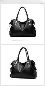 Detail of black pebbled leather texture and gold metal buckle on large tote bag