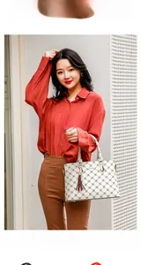 Asian model holding a beige quilted handbag with tassel detail and red shirt
