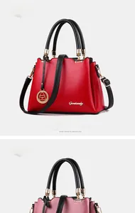 Detail of wine red bucket bag with wavy edge design and gold hardware accents