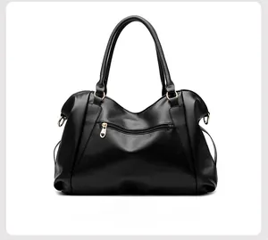 Detail view of black tote bag back zipper with heart-shaped golden metal puller