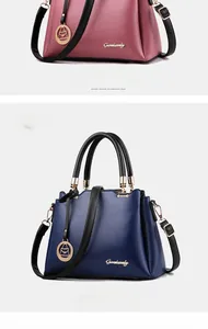 Detail view of pink and royal blue bucket bags with gold hardware and logo