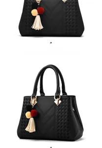 Detailansicht der schwarzen Lederhandtasche mit V-Naht und Quasten-Anhänger