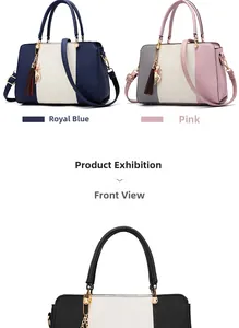 Detail of color-block tote bag with lychee texture leather and cat tassel charm
