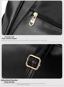 Detail of black pebbled leather bag with gold heart zipper and adjustable metal buckle
