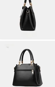Detail of black leather bucket bag showing golden hardware and back zipper pocket