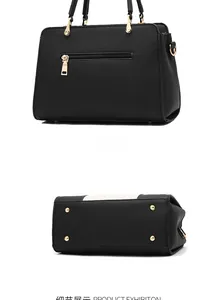 Detail view of black lychee grain handbag featuring back zipper and gold bottom studs