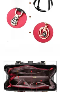 Detail of red and black handbag featuring multi-compartment interior and gold hardware