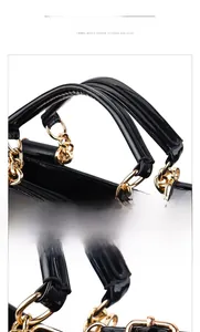 Close-up of gloss patent leather handle with gold chain link hardware for handbag