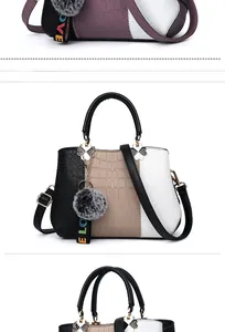 Detail view of tri-color stone pattern handbag with metallic handles and love pendant