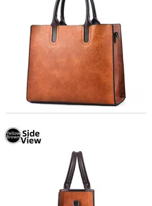 Detail view of large brown vintage leather tote bag showing side D-ring and texture