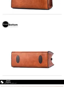 Detail view of tan leather bag showing durable bottom pads and premium textured finish