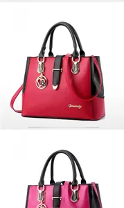 Detail view of wine red and rose tote bags with black contrast handles and metal charms