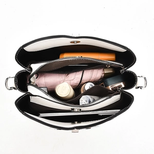 Spacious interior of black and white handbag with functional compartments for daily items