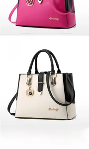 Detail view of large tote bag with heart charm in rose red and black-white color options