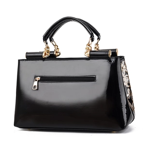 Glossy black patent leather handbag with luxury sequin embroidery and gold chain handles