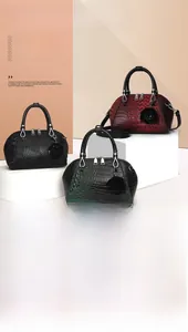 Close-up of vintage crocodile pattern leather and black rose charm on handbag