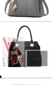 Detailed view of woven texture tote bag comparing size with iPad and stylish metal charms