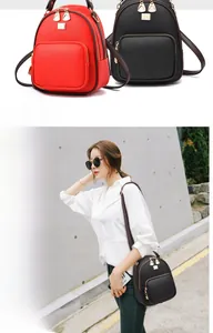 Detail view of mini litchi grain leather backpack with gold zippers in red and black