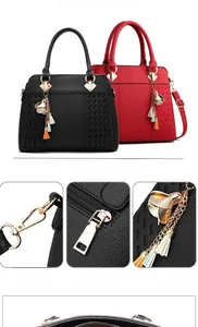 Detail of woven leather handbag showing golden hardware and floral tassel charm