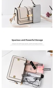 Detail view of cream crossbody bag interior showing storage for phone and makeup