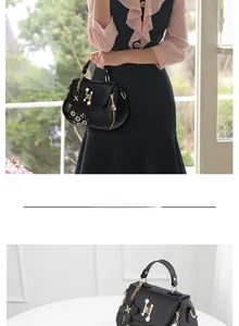 Close-up of black PU bucket bag with floral embroidery and pearl H-buckle detail
