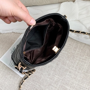 Black quilted leather chain shoulder bag with interior pocket and golden twist lock