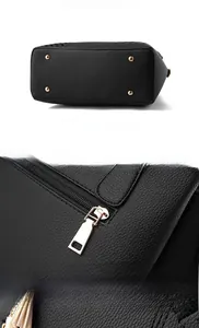 Detail of black litchi grain leather bag with gold metal feet and back zipper closure