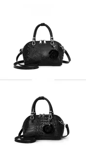 Front view detail of black crocodile texture shell bag with a 3D rose charm and silver hardware