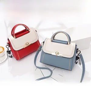 Detail of color-block handbags with metal ring handles and cartoon bear charms