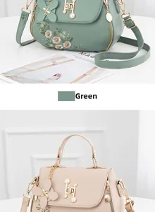 Detail of floral embroidery and pearl H-lock on elegant green and beige faux leather bags
