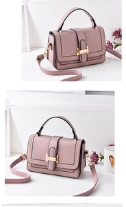 Detail of pink crossbody bag with gold H-buckle and double stitching in a stylish setting