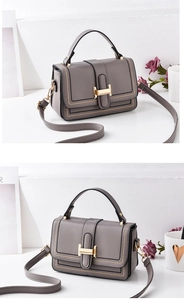 Detail of grey lychee textured crossbody bag with golden H buckle and stitching