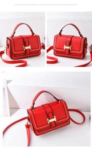 Detailed view of red structured PU leather crossbody bag with golden H buckle and stitching
