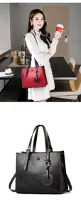 Detail of red and black tote bags with lychee leather texture and gold hardware details