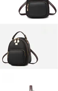 Detail view of black litchi grain leather mini backpack with gold hardware and brown straps