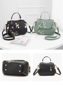 Detail of floral embroidery, H-shaped metal buckle and protective bottom studs on bag