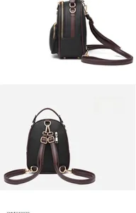 Detail view of black lychee grain backpack with brown straps and golden zippers