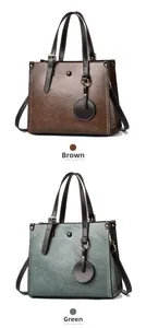 Detail view of lychee texture synthetic leather tote bags in brown and green colors