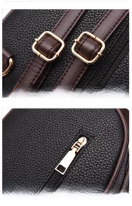 Macro shot of adjustable shoulder straps with polished gold buckles on pebbled leather bag