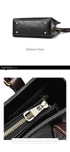 Detail view of black lychee leather bag base with gold studs and textured metal zipper