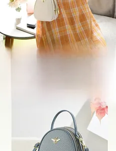 Detail of mini handbag with woven texture and gold bee hardware for women