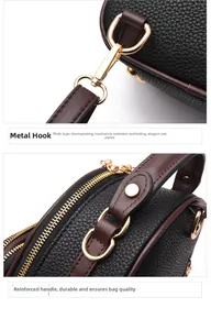 Detail of gold-tone hardware clasp and reinforced stitching on leather handbag